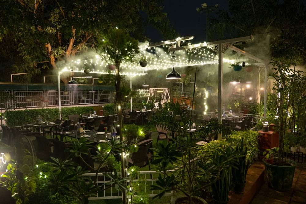 Greenhouse dining under string lights